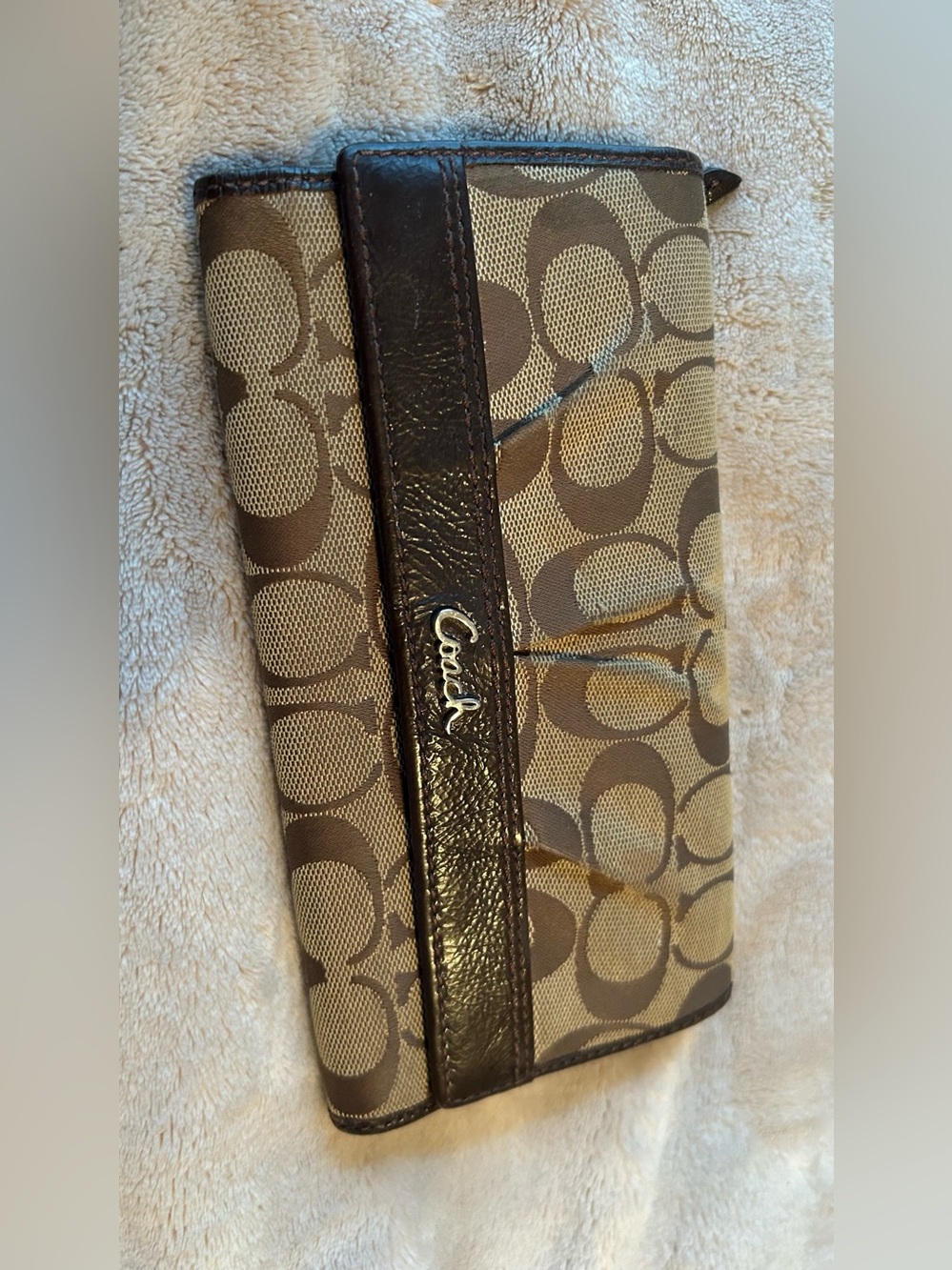 vintage Coach Signature canvas trifold wallet featuring brown monogram fabric